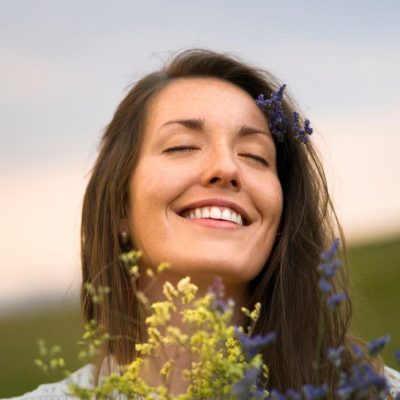 front-view-smiley-woman-holding-flowers